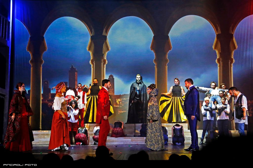 Scena d'apertura con archi e città di Verona sullo sfondo